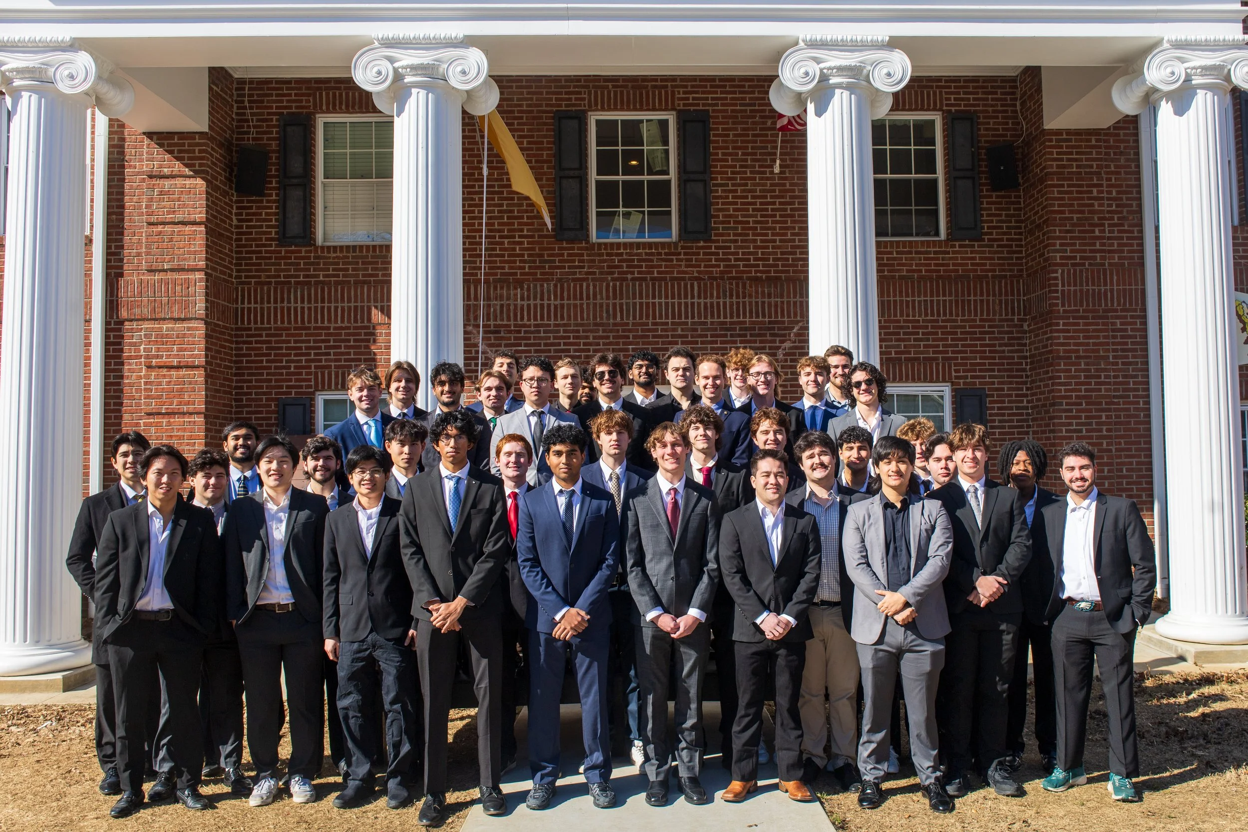 The brothers of Phi Kappa Theta in front of the chapter house